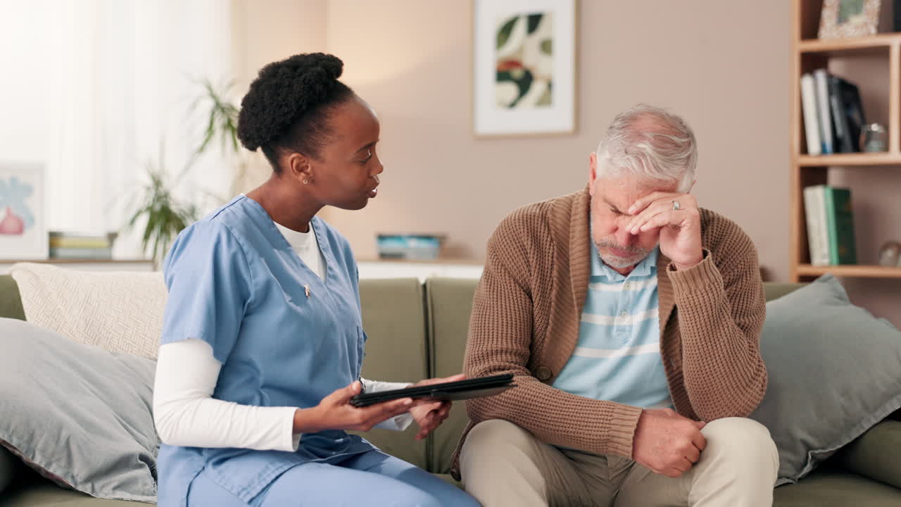 Nurse consoling a senior man with depression