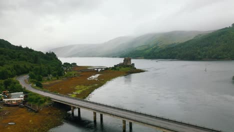 Aerial-Flyover-Bridge-next-to-Eilean-Donan-Castle,-Loch-Duich,-Scottish-Highlands,-Scotland