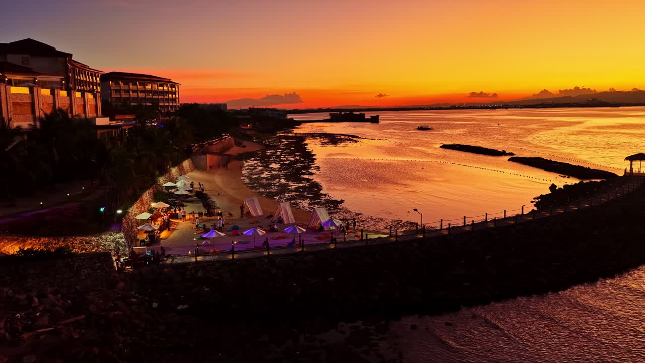 Resort à beira-mar iluminado sob um céu de pôr do sol vibrante, perfeito para promoções de viagens. Filipinas.