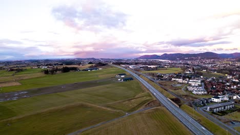 Road-Riksvei444-splitting-Sandnes-with-agriculture-land-of-Jæren,-Sandnes-Rogaland