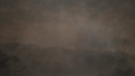 animation of fire smoke flying over dense black clouds
