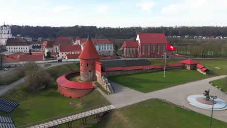 Drone-shot-of-the-historic-old-red-brick-Kaunas-Castle-in-Kaunas-old-town,-Lithuania,-parallax-shot