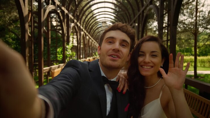 Cute couple having video call in park