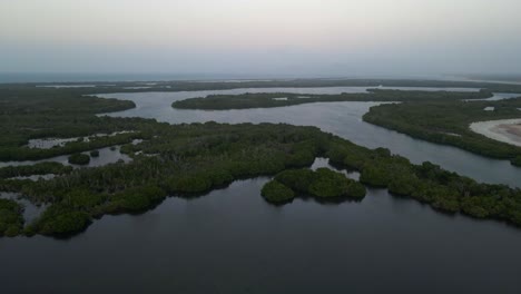 drone moves forward flying over these islands and mangrove forests in this extended body of water at a coastal area in porlamar, margarita island, venezuela