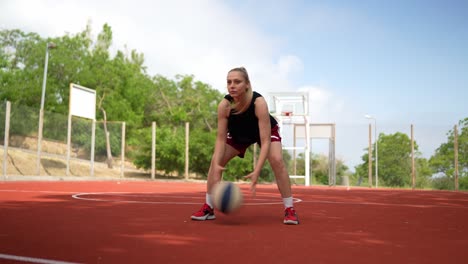 woman playing basketball outdoors