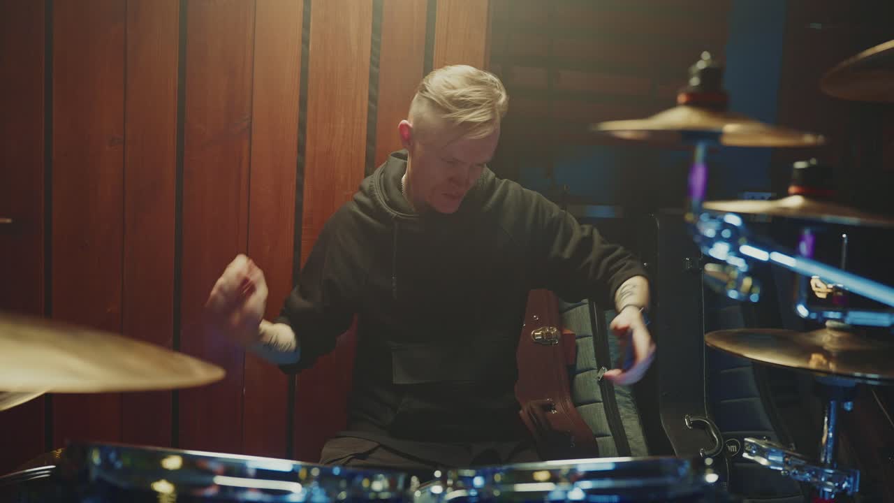 Drummer playing drums in a studio