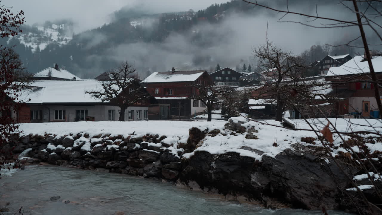 Serene view of the Weisse L&uuml;tschine river in Lauterbrunnen, Switzerland, captured on a tranquil, snowy winter day, showcasing the ethereal beauty of nature