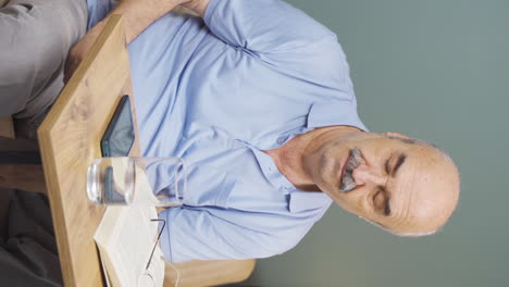 Vertical-video-of-The-old-man-arguing-with-his-girlfriend-is-desperate-on-the-end-of-the-phone.