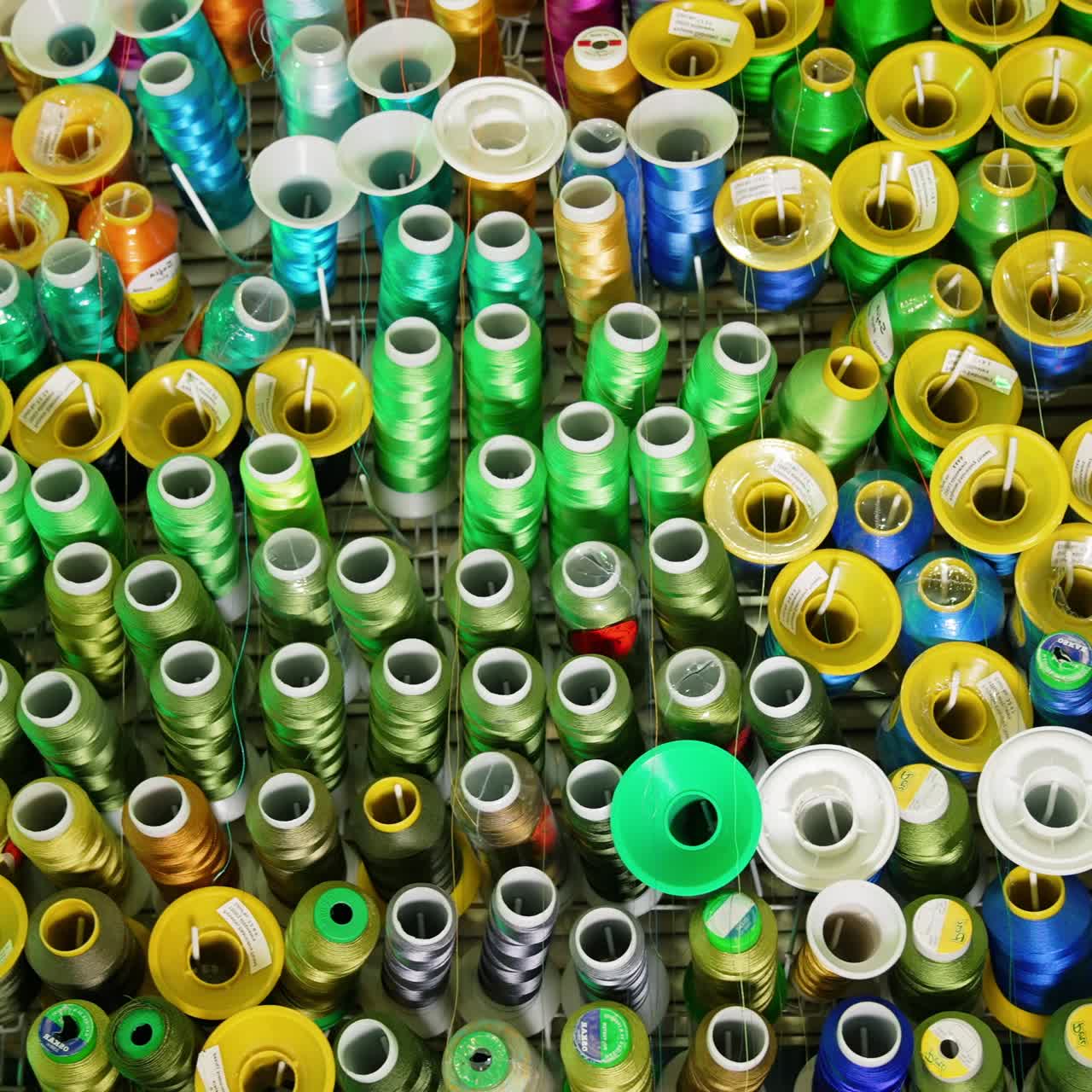 Sewing colorful threads hanging on a wall. Design cotton accessories