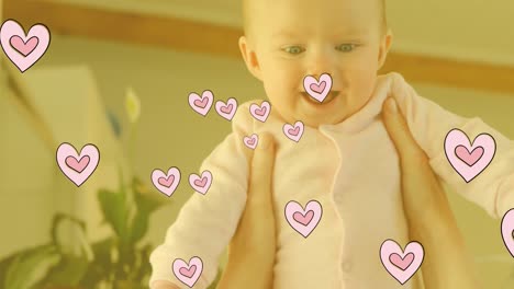 animación de corazones cayendo sobre feliz caucásico bebé feliz