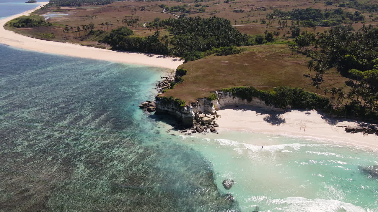 vista aérea de la playa de pantai watu bella con arena blanca y agua cristalina en un día soleado en la isla de sumba, indonesia