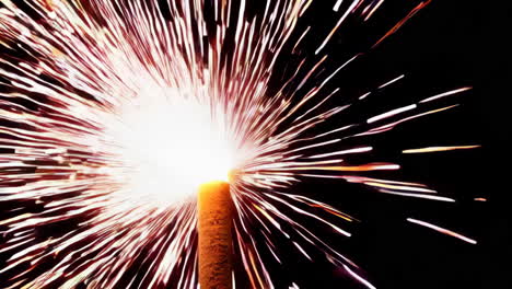 sparkler burning and emitting bright sparks in the dark