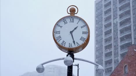 street clock during a snowstorm