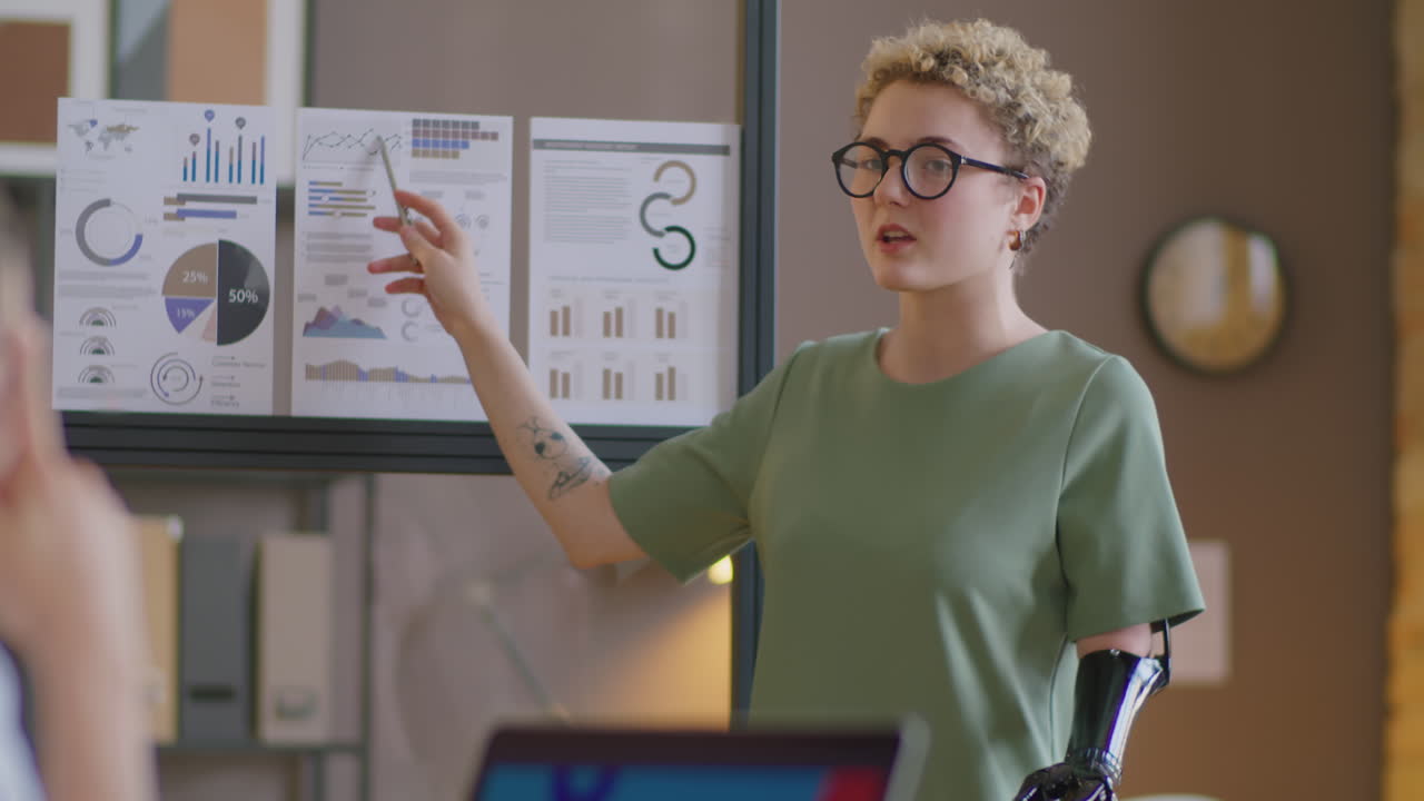 Businesswoman with Prosthetic Arm Giving Presentation in Office