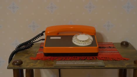 vintage orange rotary dial telephone exhibit