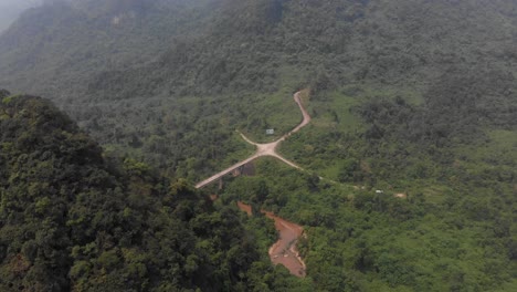 Wide-view-of-a-crossing-at-highway-QL15-at-Vietnam,-aerial