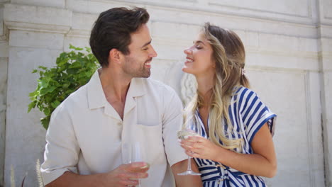 romantic pair celebrating vacation at patio closeup. lovers holding wineglasses