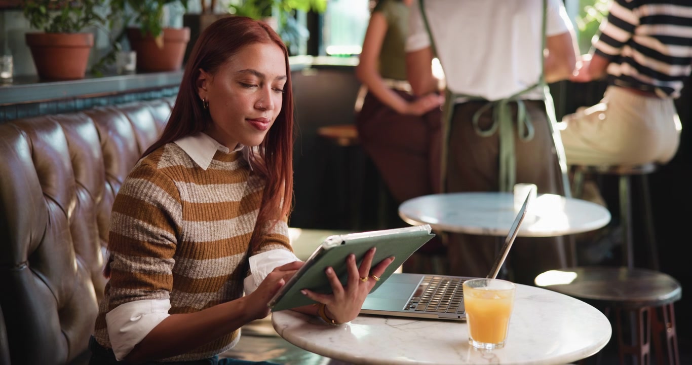 Young Woman Using Tablet in a Cafe