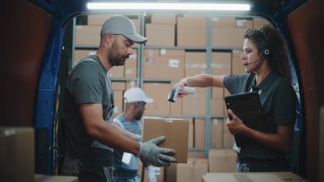logistics team loading and scanning packages in a delivery van