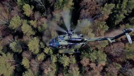 military helicopter over forest