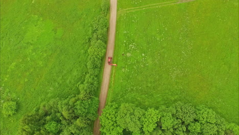 drone shot of a tractor mowing the grass verge