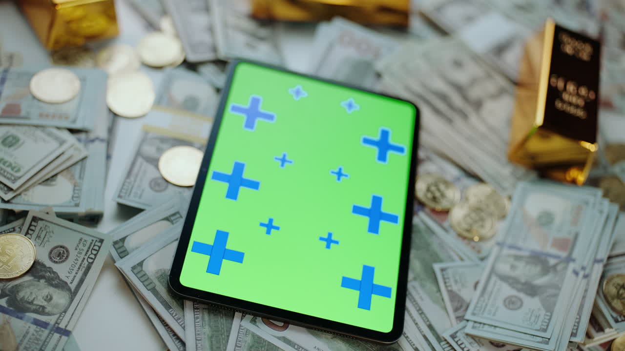 Soldi, oro e tablet con schermo verde