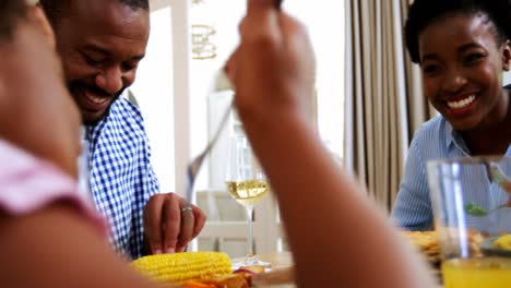 Family-having-meal-on-dinning-table-at-home