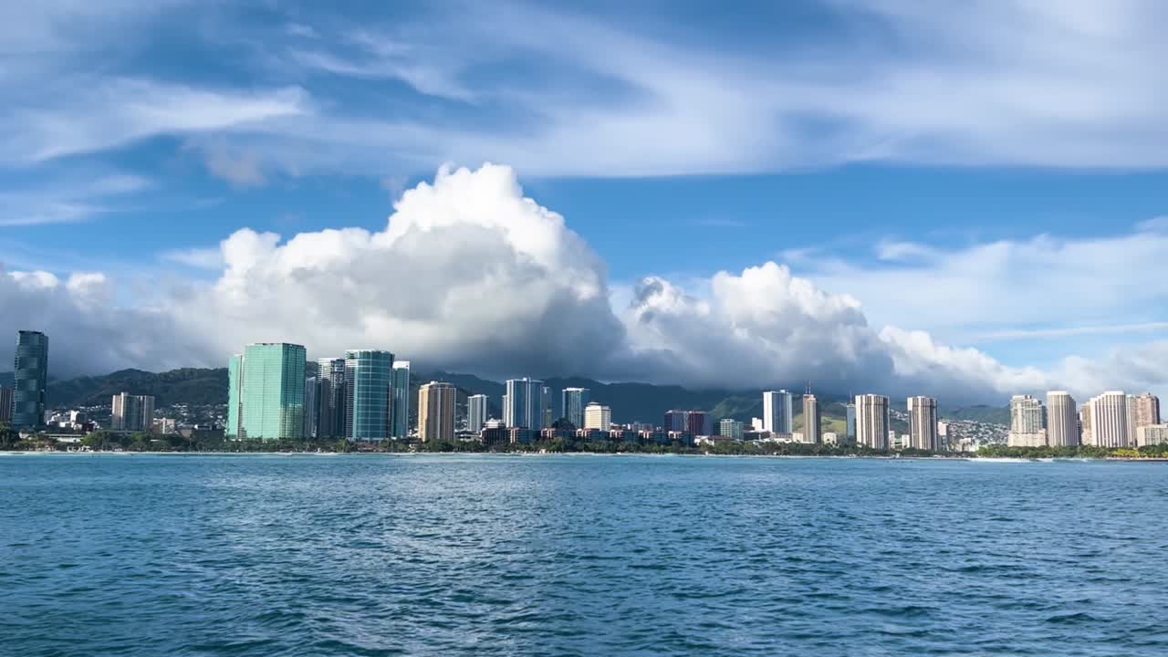Honolulu city skyline beneath fluffy clouds on a sunny day in Oahu