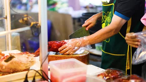 vendors slicing and packaging roasted chicken