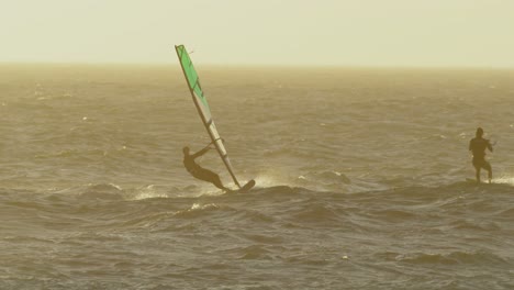 male surfers windsurfing in the beach 4k