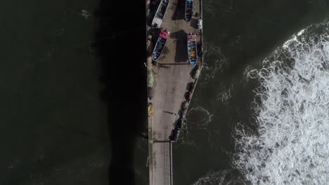 Top-View-Of-People-Walking-On-Pier-Through-Boats-And-Restaurants