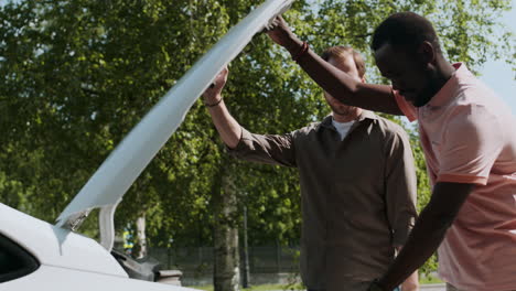 Opening-car-hood-during-driving-lesson