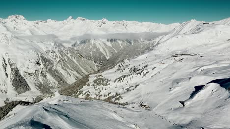 Amazing-view-over-Austrian-Alps-mountain-peaks-in-winter-snow,-aerial-4K