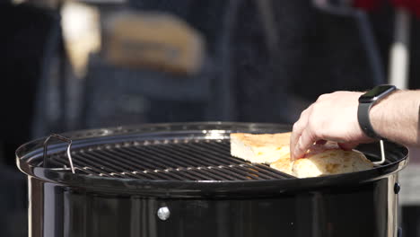 chef toasting bread in a charcoal griller