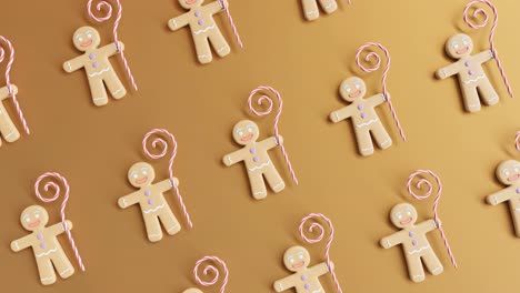 hombres de pan de jengibre y bastones de caramelo sobre un fondo amarillo