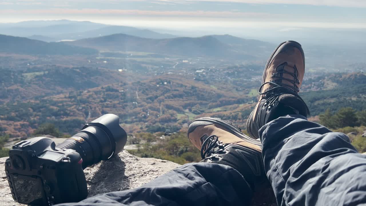 POV shot of a person relaxing in the mountains of Madrid, gently moving their leg while enjoying the peaceful landscape