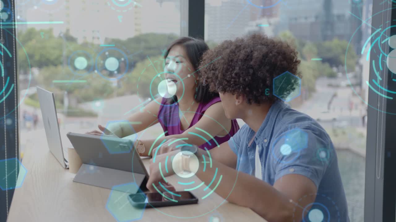 Two students studying at window, left pointing tablet, right tapping phone, HUD hovering screens