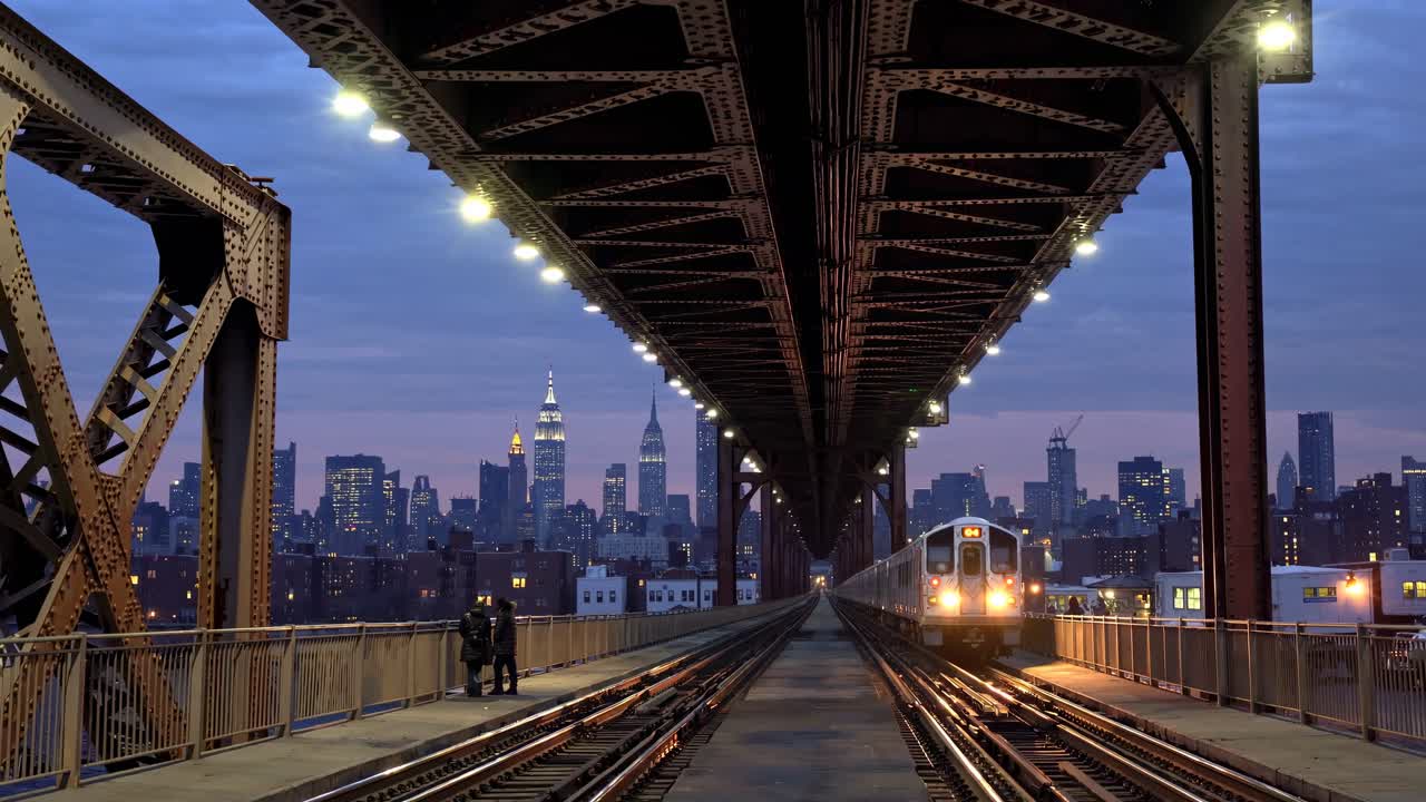 Dramatic cityscape video scene with a low-angle view under a bridge, capturing a train approaching