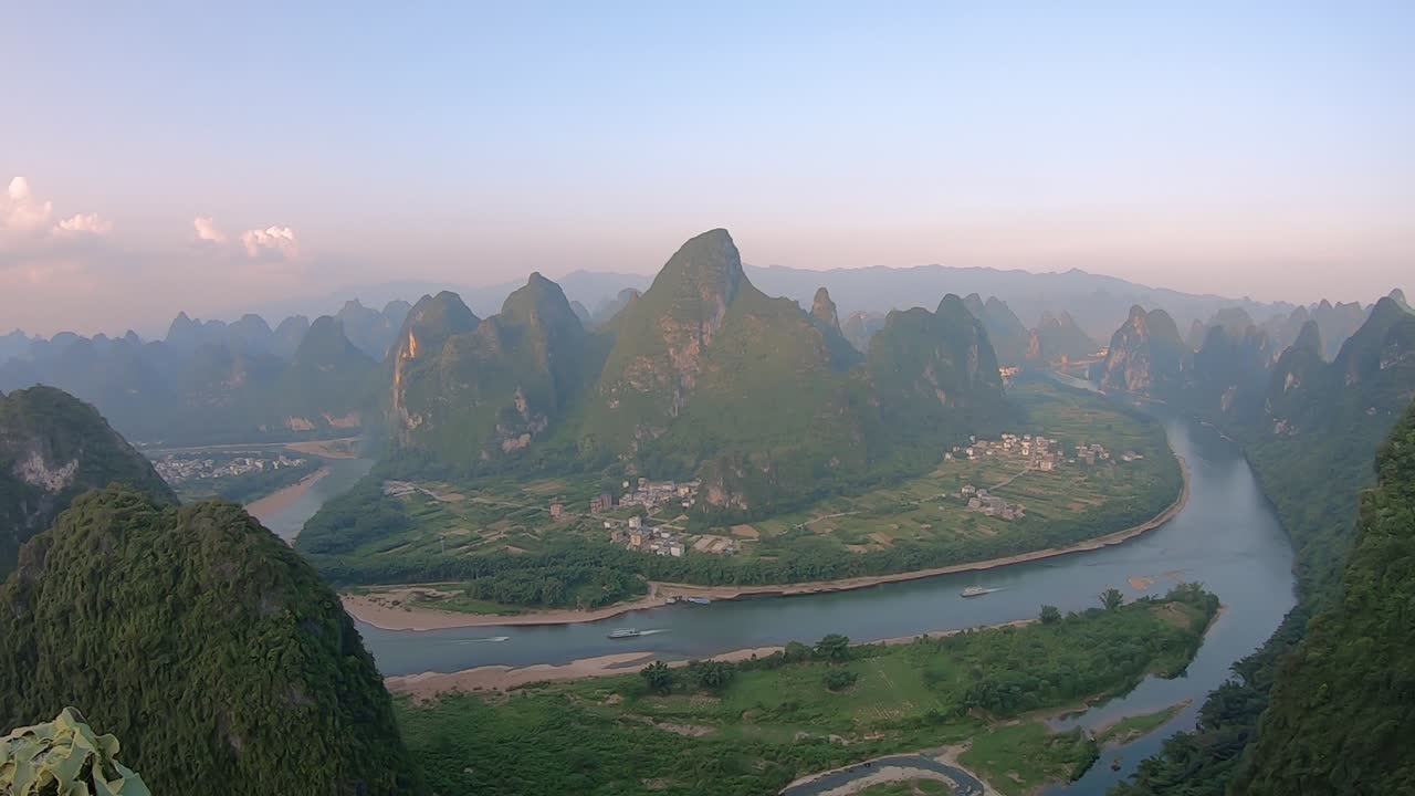 Time-lapse clip of sunset over Li River as seen from the Xianggong Hill viewpoint over lush and dense karst mountain landscape in Yangshuo, Guangxi Province, China