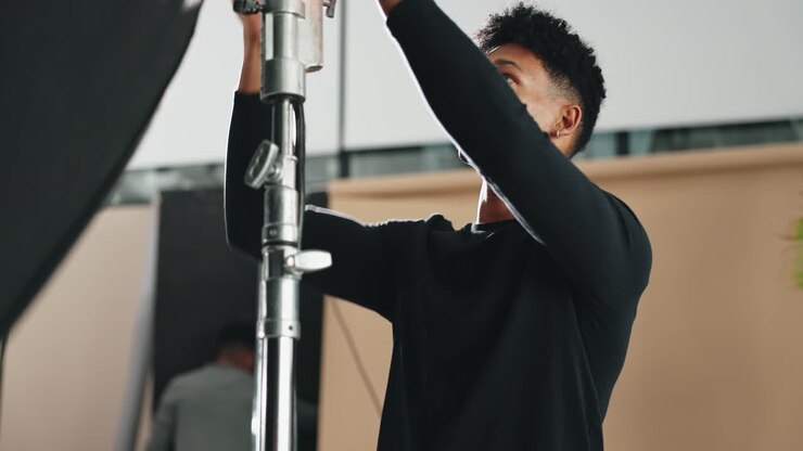 Photographer Setting Up Studio Lighting