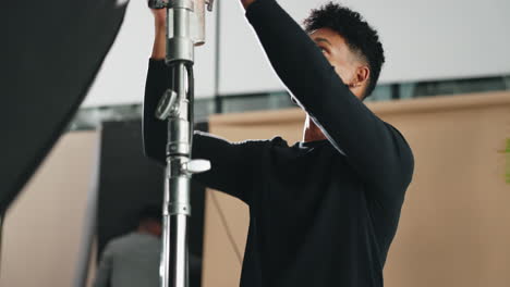 photographer setting up studio lighting