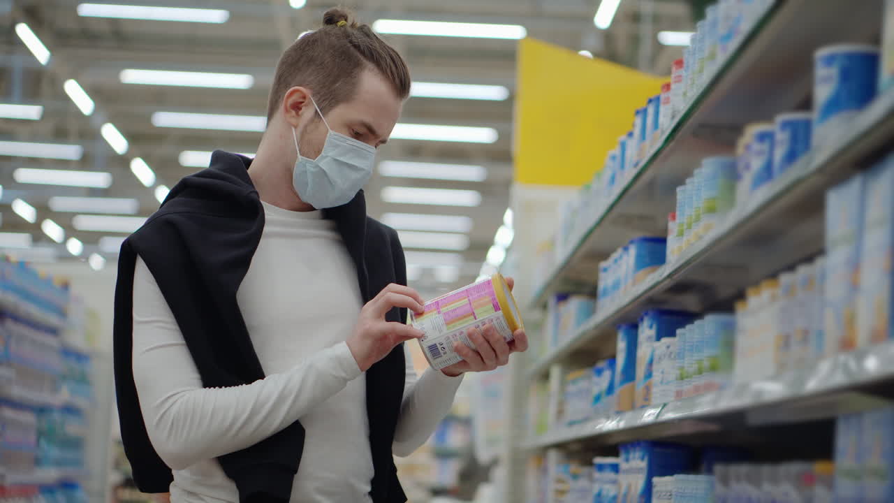 Person Shopping for Food in a Grocery Store Wearing a Mask