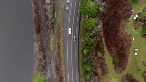aerial birds eye static shot of highway, train tracks and power lines