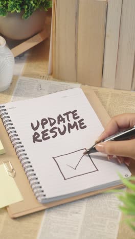 vertical video of ticking off update resume work from checklist