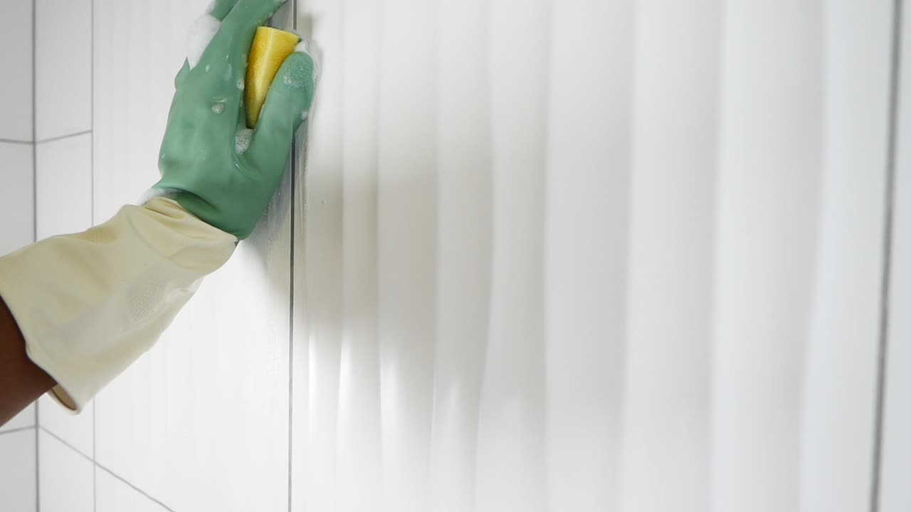 Cleaning Bathroom Tiles with Gloves and Sponge