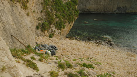 Thrown-Garbage,-Plastic-Bottles-and-Tires-by-Mediterranean-Sea,-Malta-Island