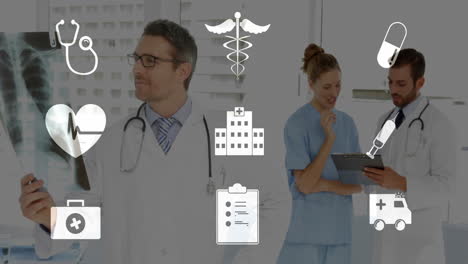 medical icons animating over healthcare professionals working in hospital