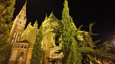 the impressive building and tower of the szeged cathedral from behind at night in hungary