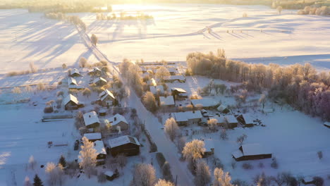 establishing winter morning aerial of rural village with long tree shadows