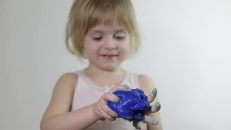 child having fun making slime. kid playing with hand made toy slime.